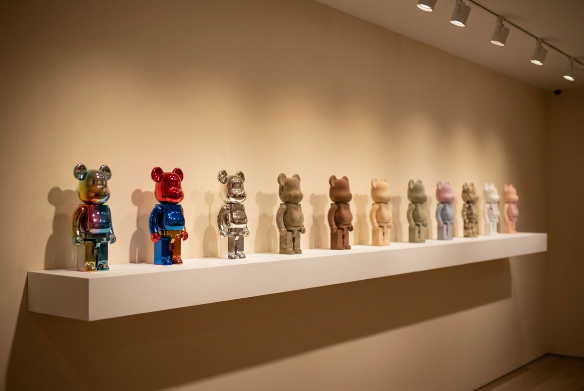 A row of authentic BE@RBRICK collectible bear figures displayed on a gallery shelf under museum lighting
