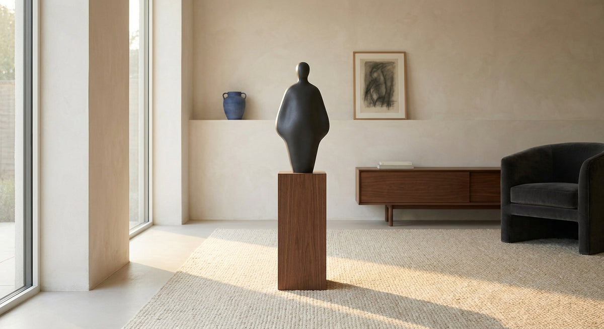 An original abstract vinyl sculpture styled on a walnut plinth in a contemporary home
